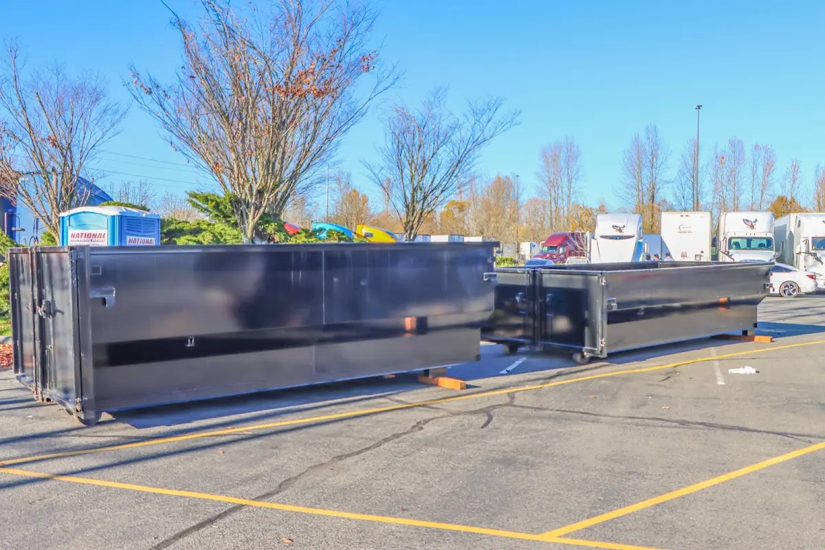 Professional dumpster rental service with roll-off container on residential driveway in Waverly